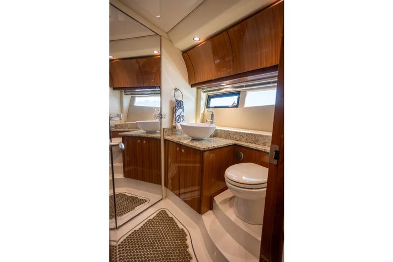 Slide: The Image of Luxurious bathroom interior of 2018 Cobalt 46 Yacht with modern fixtures and wood accents. - 23
