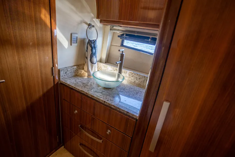 Slide: The Image of Luxurious bathroom interior of 2018 Cobalt 46 Yacht with modern sink and wooden cabinetry. - 25