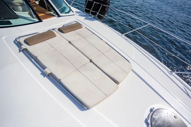 Slide: The Image of 2018 Cobalt 46 Yacht sunbathing deck with cushions, overlooking the ocean. - 29