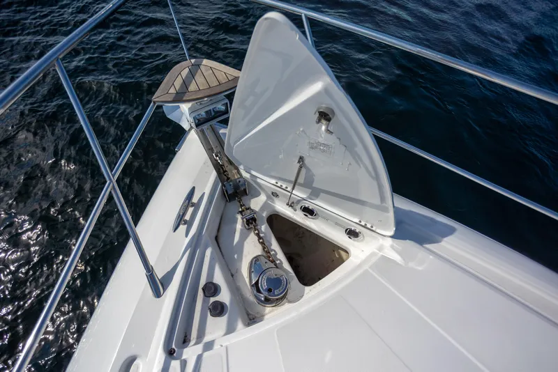 Slide: The Image of Bow of 2018 Cobalt 46 Yacht with anchor compartment open, on calm water. - 32