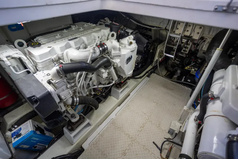 Slide: The Image of Engine room of a 2018 Cobalt 46 Yacht, showcasing mechanical components and equipment. - 34