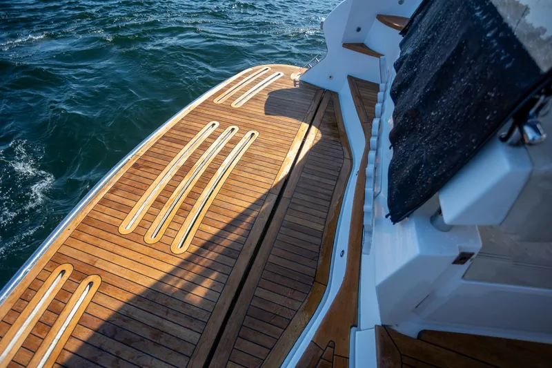 Slide: The Image of 2018 Cobalt 46 Yacht with teak deck, cruising on water. - 4