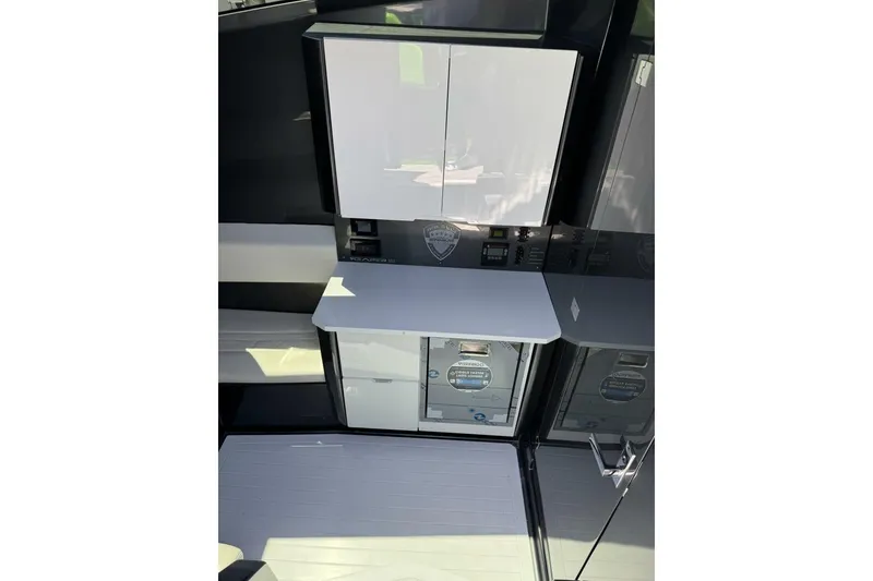 Slide: The Image of Modern interior of 2023 Adrenaline 47 boat with sleek cabinetry and control panel. - 13