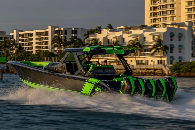 Slide: The Image of High-speed Adrenaline 47 boat cruising near modern waterfront buildings, 2023 model. - 4