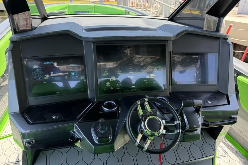 Slide: The Image of Cockpit of 2023 Adrenaline 47 boat with advanced digital displays and steering wheel. - 5