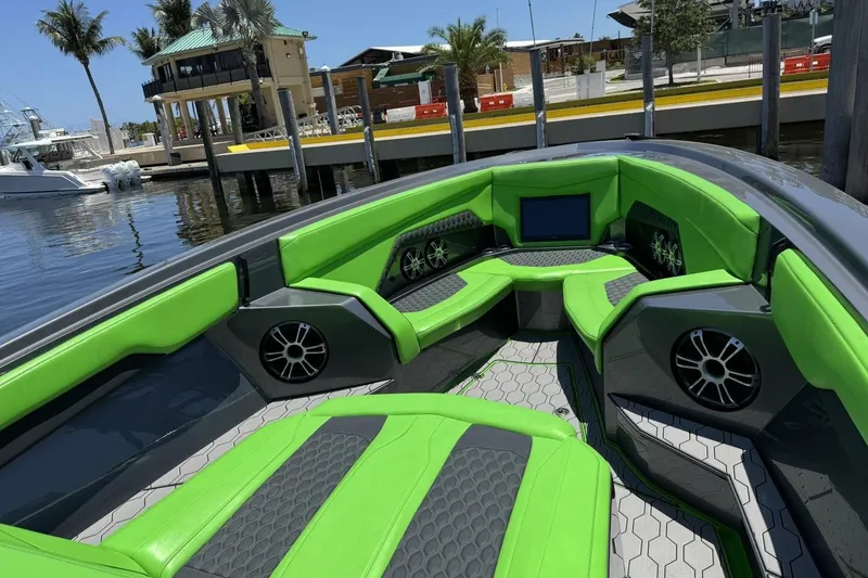 Slide: The Image of 2023 Adrenaline 47 boat interior with vibrant green seating and modern design. - 7