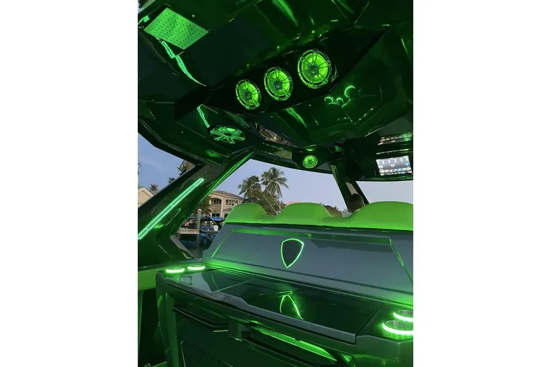Slide: The Image of Interior of 2023 Adrenaline 47 boat with vibrant green LED lighting. - 9