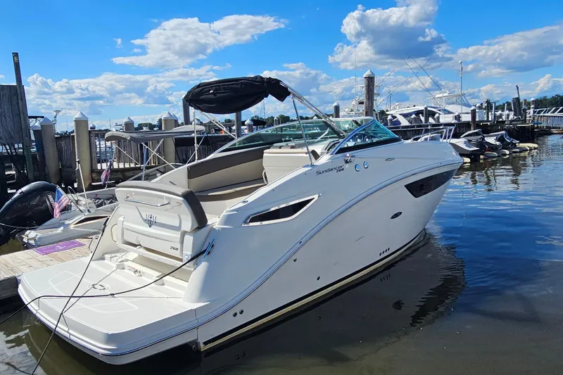 The Image of 2015 Sea Ray 260 Sundancer boat docked at marina under blue sky. - 0