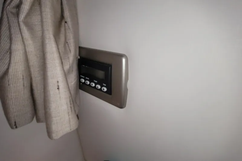 Slide: The Image of Control panel on 2015 Sea Ray 260 Sundancer boat interior, next to beige curtain. - 20