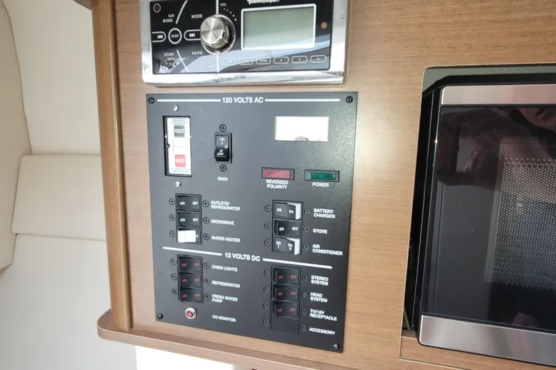 Slide: The Image of Control panel of a 2015 Sea Ray 260 Sundancer boat, featuring electrical switches. - 23
