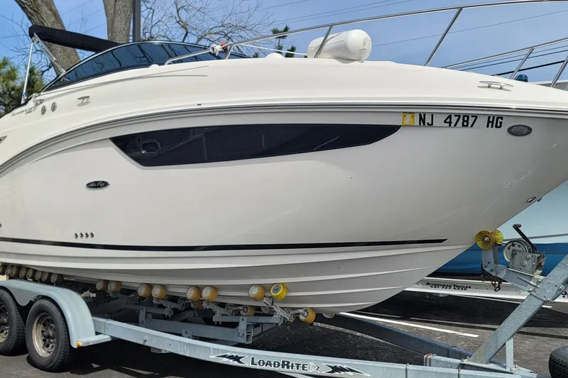 Slide: The Image of 2015 Sea Ray 260 Sundancer boat on trailer, side view, registration NJ 4787 HG. - 32