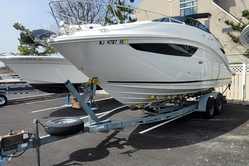 Slide: The Image of 2015 Sea Ray 260 Sundancer boat on trailer in parking lot. - 33