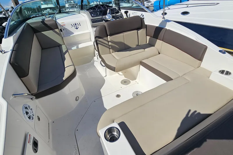 Slide: The Image of 2015 Sea Ray 260 Sundancer boat interior with beige seating and modern dashboard. - 7