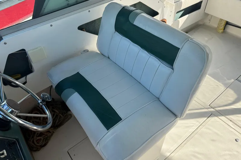 Slide: The Image of 1989 Sea Ray 300 Weekender boat interior with white and green seating. - 11