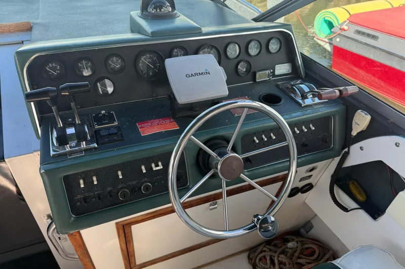 Slide: The Image of 1989 Sea Ray 300 Weekender helm with Garmin GPS, steering wheel, and control panel. - 13