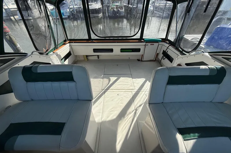 Slide: The Image of 1989 Sea Ray 300 Weekender boat interior with seating and marina view. - 14