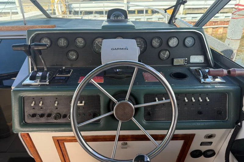 Slide: The Image of 1989 Sea Ray 300 Weekender helm with Garmin navigation, gauges, and controls. - 17