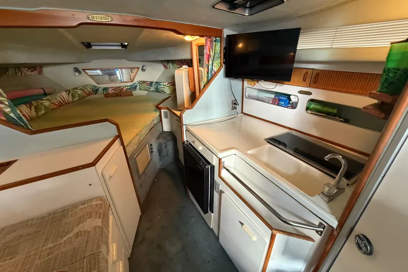 Slide: The Image of Interior of 1989 Sea Ray 300 Weekender boat with kitchenette and sleeping area. - 21