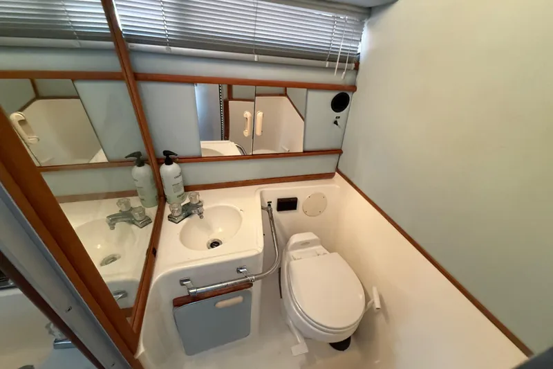 Slide: The Image of Bathroom interior of 1989 Sea Ray 300 Weekender with sink and toilet. - 23