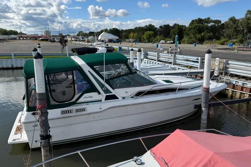 Slide: The Image of 1989 Sea Ray 300 Weekender docked at marina with green canopy. - 3