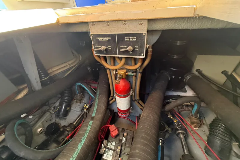 Slide: The Image of Engine compartment of a 1989 Sea Ray 300 Weekender with fuel selector and fire extinguisher. - 32