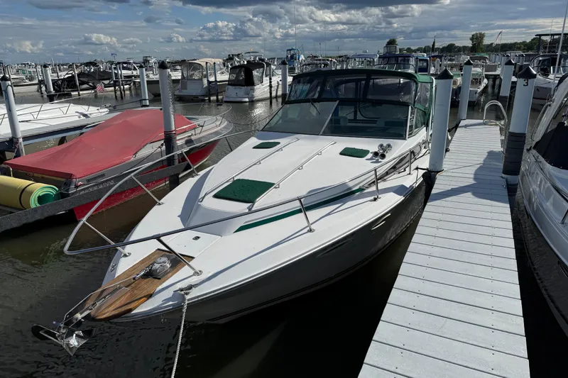 Slide: The Image of 1989 Sea Ray 300 Weekender docked at marina under cloudy sky. - 4