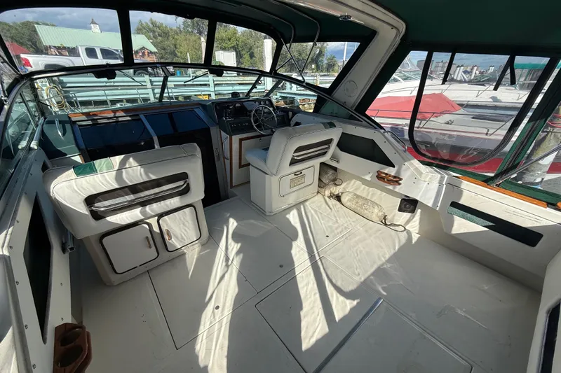 Slide: The Image of 1989 Sea Ray 300 Weekender boat interior with helm, seating, and dashboard. - 6