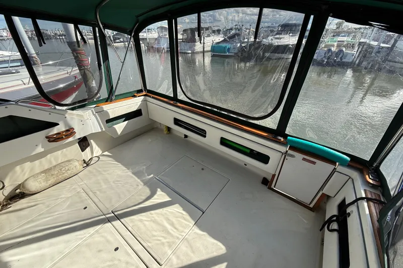 Slide: The Image of 1989 Sea Ray 300 Weekender boat interior with marina view through windows. - 7