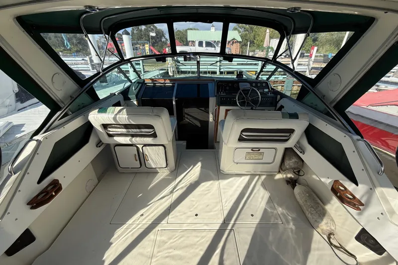 Slide: The Image of 1989 Sea Ray 300 Weekender boat interior with helm, seats, and dashboard. - 8