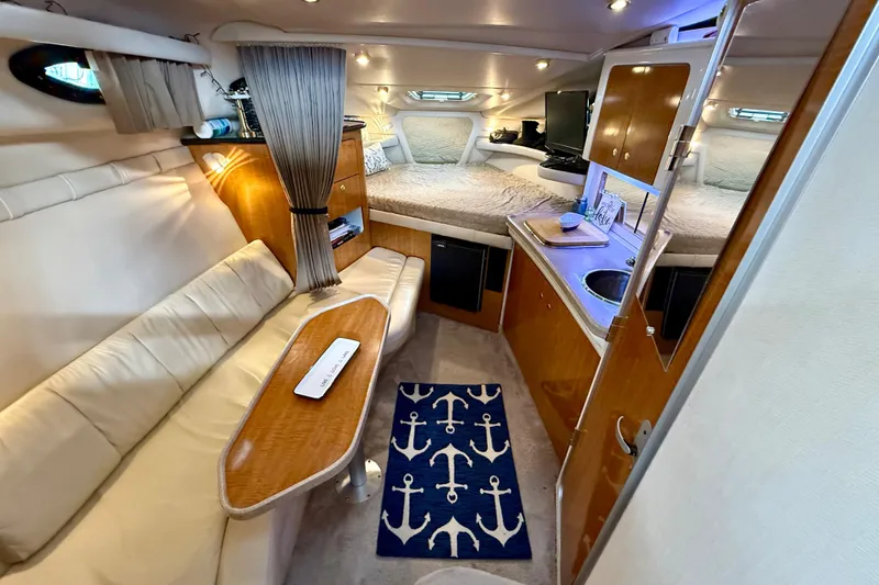 Slide: The Image of Luxurious interior of 2002 Regal Commodore 2860 yacht with cozy seating and kitchenette. - 10