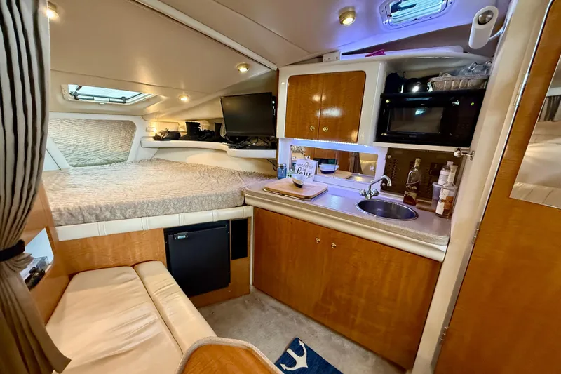 Slide: The Image of Luxurious interior of 2002 Regal Commodore 2860 yacht with kitchenette and cozy sleeping area. - 11