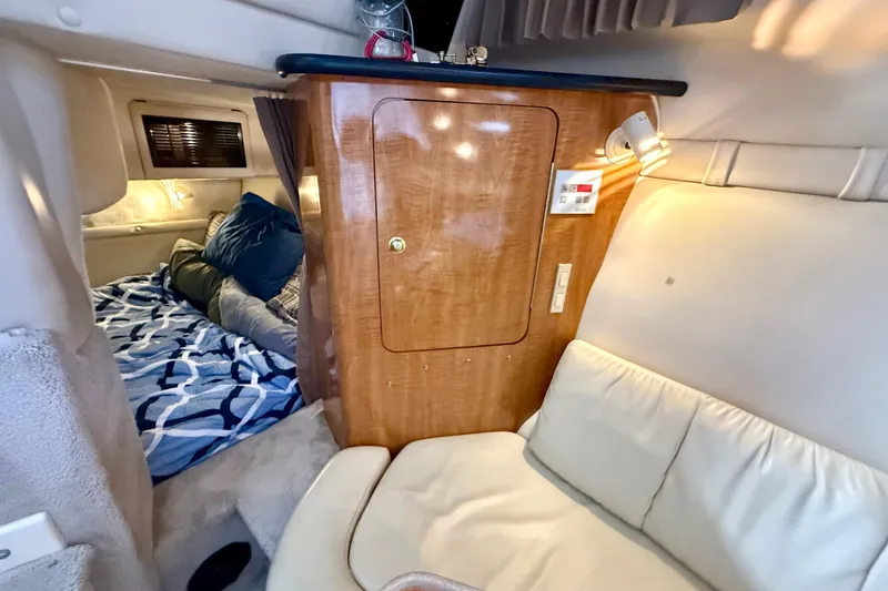 Slide: The Image of Interior of 2002 Regal Commodore 2860 boat with cozy cabin and wooden cabinetry. - 15