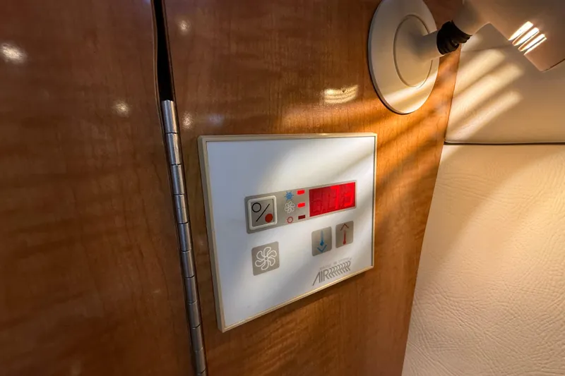 Slide: The Image of Control panel on 2002 Regal Commodore 2860 boat, featuring temperature and fan settings. - 16