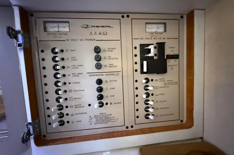 Slide: The Image of Electrical control panel of 2002 Regal Commodore 2860 boat, featuring switches and gauges. - 17