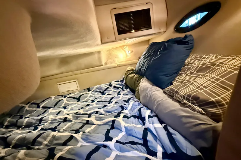 Slide: The Image of Interior cabin of 2002 Regal Commodore 2860 with cozy bedding and pillows. - 20