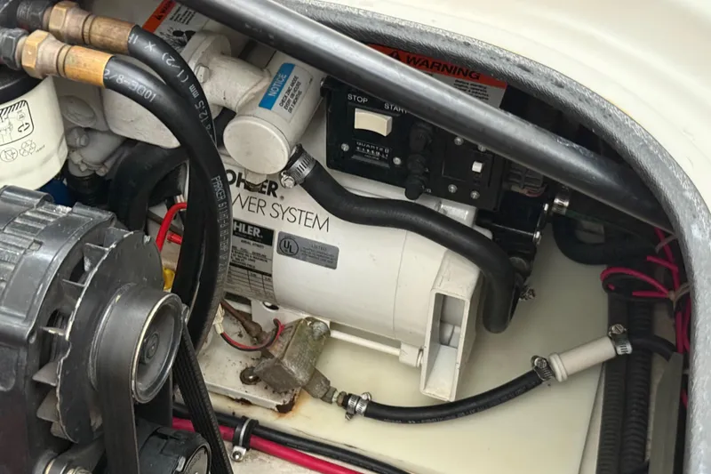 Slide: The Image of Engine compartment of a 2002 Regal Commodore 2860 boat, featuring a Kohler power system. - 29
