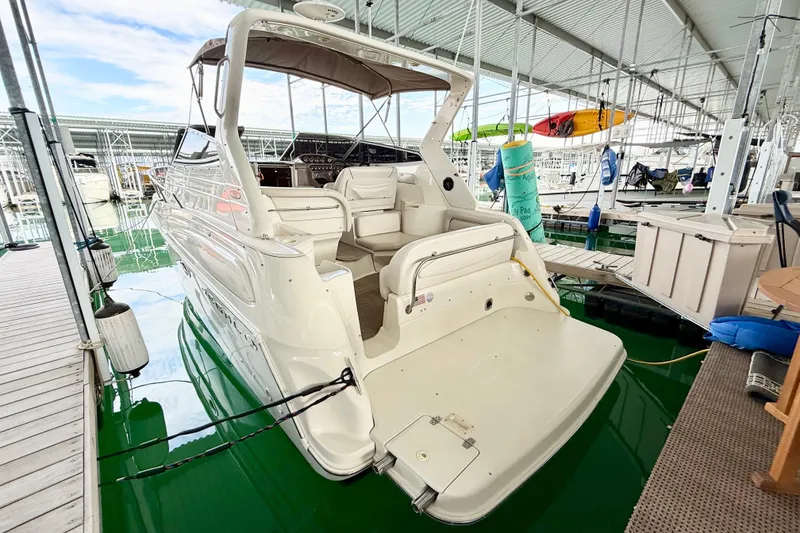 Slide: The Image of 2002 Regal Commodore 2860 boat docked in a marina, showcasing spacious deck and seating. - 3