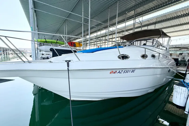 Slide: The Image of 2002 Regal Commodore 2860 boat docked in a covered marina. - 33