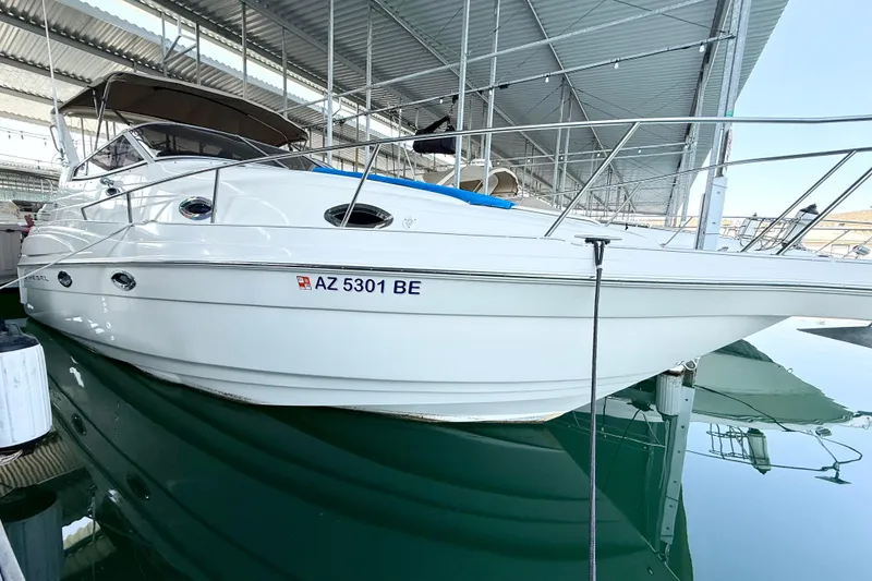 Slide: The Image of 2002 Regal Commodore 2860 boat docked in a covered marina. - 34
