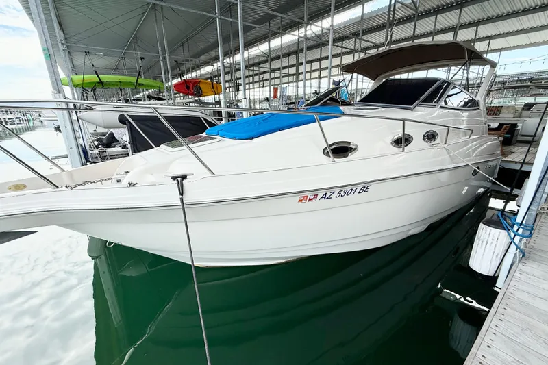 Slide: The Image of 2002 Regal Commodore 2860 boat docked in a marina under a covered structure. - 36