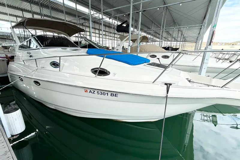 Slide: The Image of 2002 Regal Commodore 2860 boat docked in a covered marina. - 38