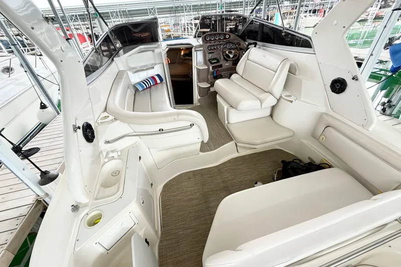 Slide: The Image of 2002 Regal Commodore 2860 boat interior with white seating and control panel. - 5