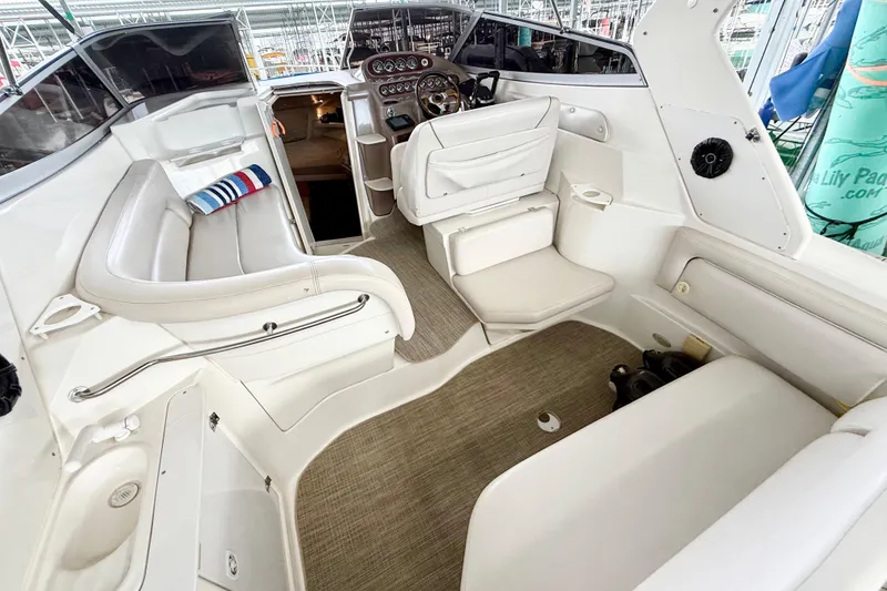 Slide: The Image of 2002 Regal Commodore 2860 boat interior with white seating and steering area. - 7