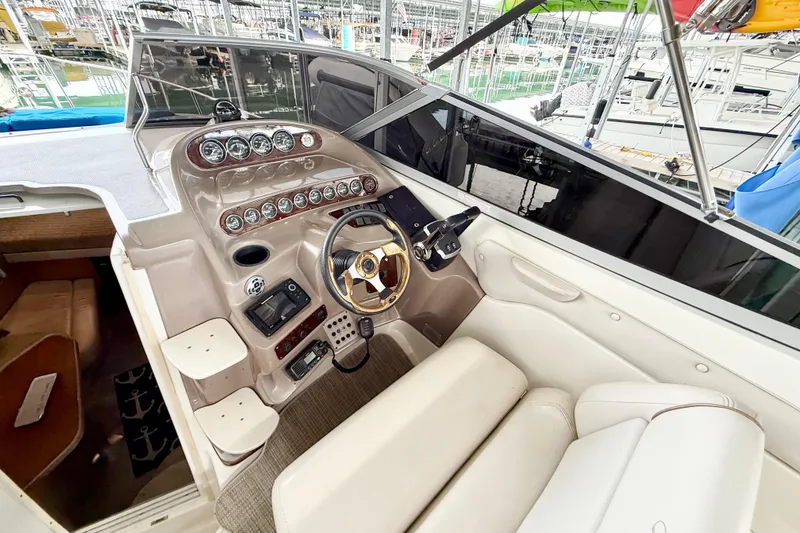 Slide: The Image of 2002 Regal Commodore 2860 boat cockpit with steering wheel and control panel. - 8