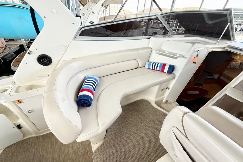 Slide: The Image of 2002 Regal Commodore 2860 boat interior with white seating and striped towels. - 9