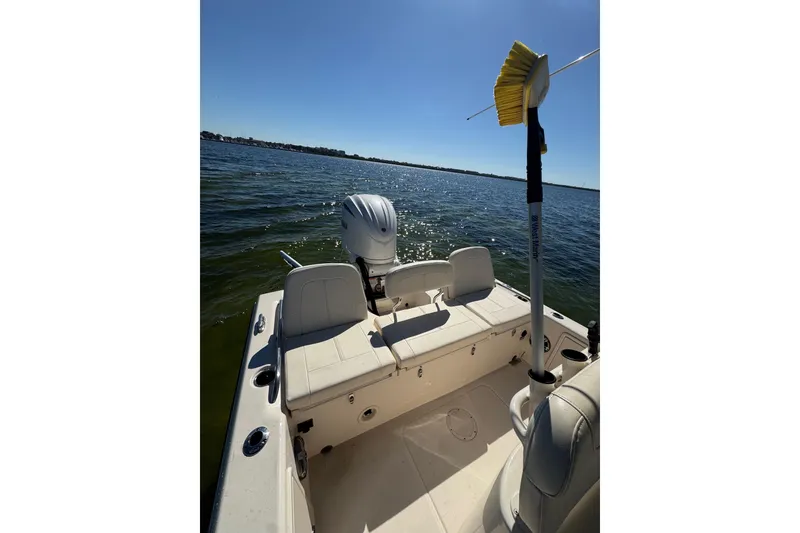 Slide: The Image of 2023 Grady-White 251 Coastal Explorer boat on calm water, featuring a clean deck and seating. - 10