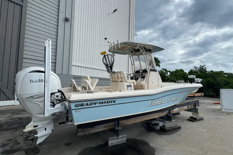 Slide: The Image of 2023 Grady-White 251 Coastal Explorer boat with Yamaha engine, docked outdoors. - 14