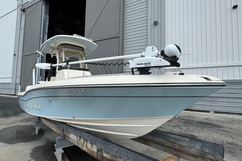 Slide: The Image of 2023 Grady-White 251 Coastal Explorer boat on trailer, featuring Minn Kota Terrova motor. - 16