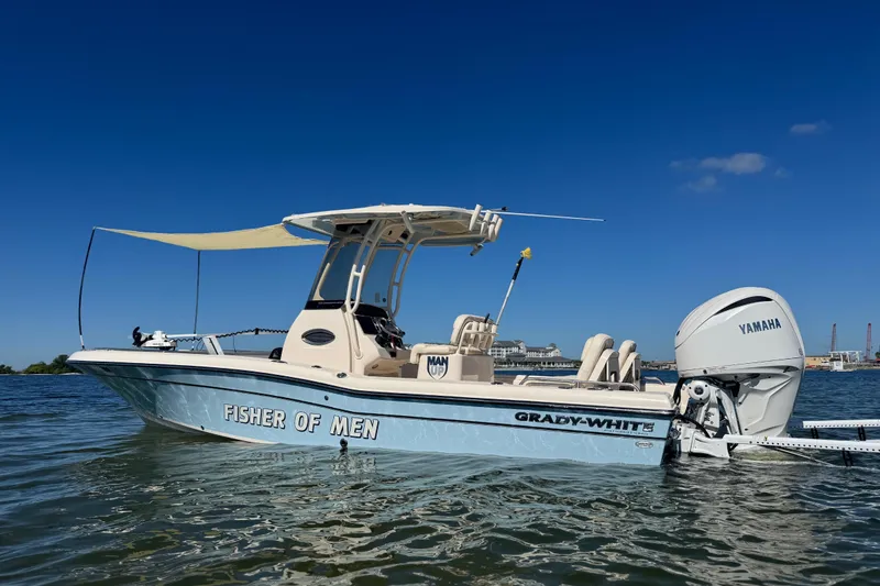 Slide: The Image of 2023 Grady-White 251 Coastal Explorer boat with Yamaha engine on calm water. - 2
