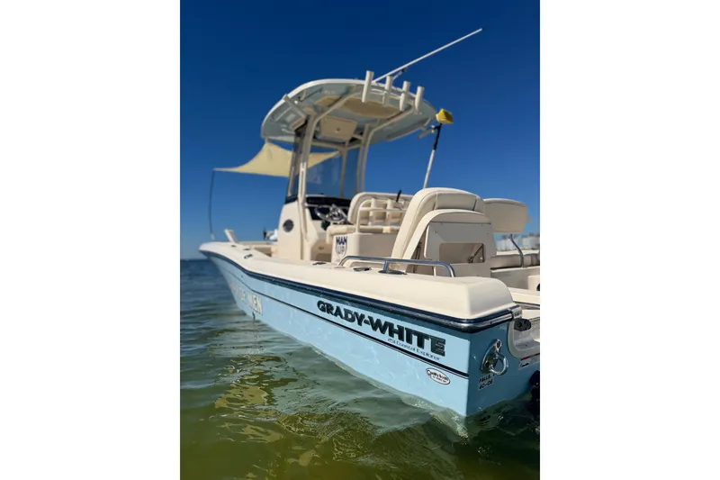 Slide: The Image of 2023 Grady-White 251 Coastal Explorer boat on water, clear blue sky background. - 3
